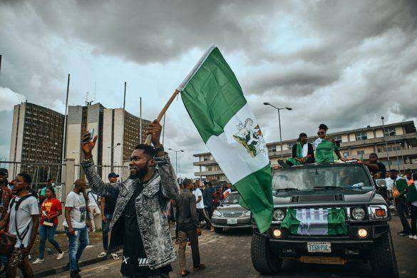 A photo of a Nigerian youth waving the flag of Nigeria