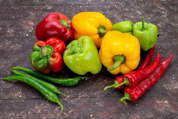 front-view-colorful-bell-peppers-with-peppers-brown-background-vegetable-color