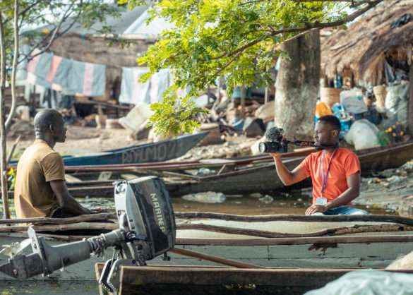 Photo of Wisdom Tetteh shooting video of a fisherman at Kpong